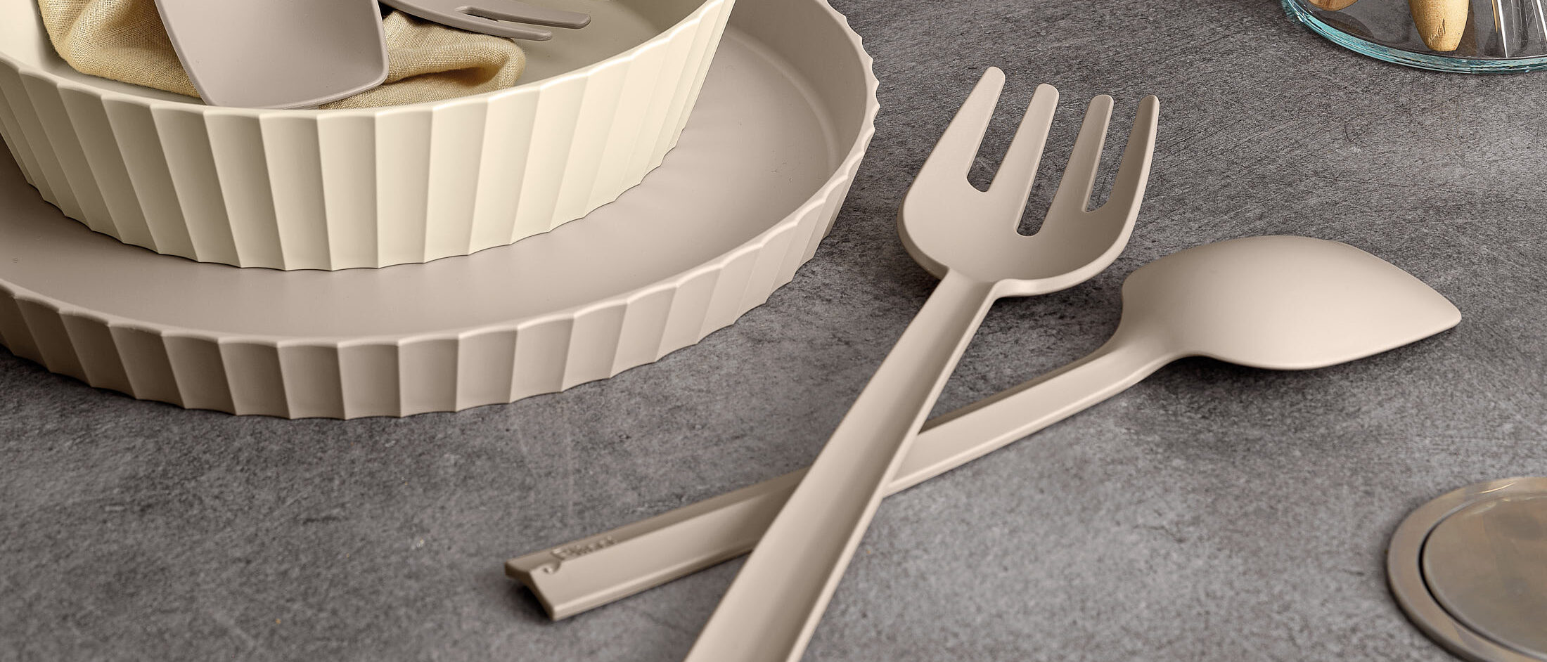 Cutlery Paestum Blim Plus in color Brown Sugar: fork and knife on gray surface, modern tableware set.