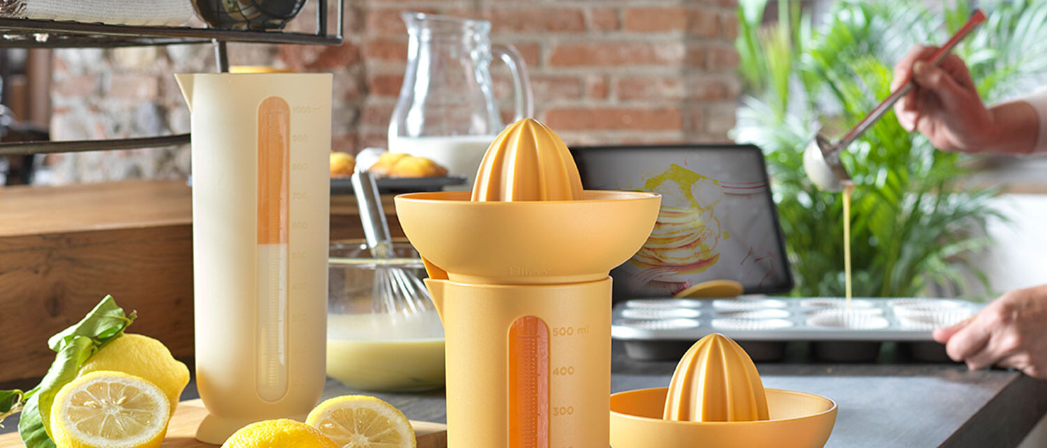 Blim Plus UFO color Desert yellow on a kitchen counter with lemons and a citrus juicer